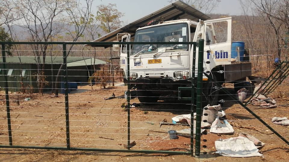 Barrett Electronics Products truck with green metal fence