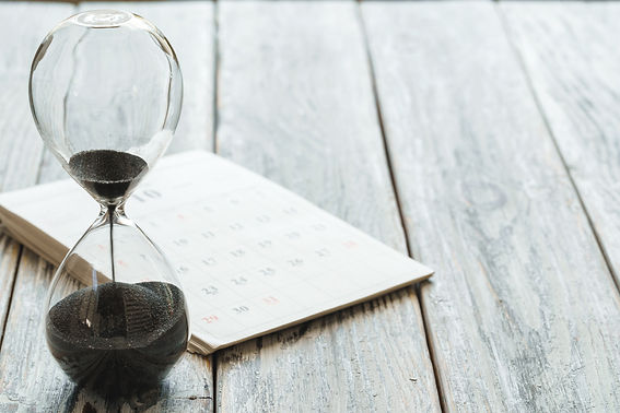 hourglass-with-calendar-on-wooden-desk-close-up-2021-09-03-17-46-17-utc.jpeg