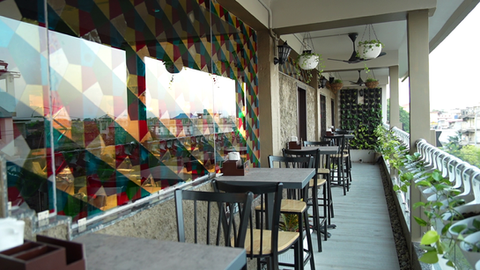 Seating setup in the Balcony of Cafe Monjaai with natural plantation to bring positive feel in the customers. 