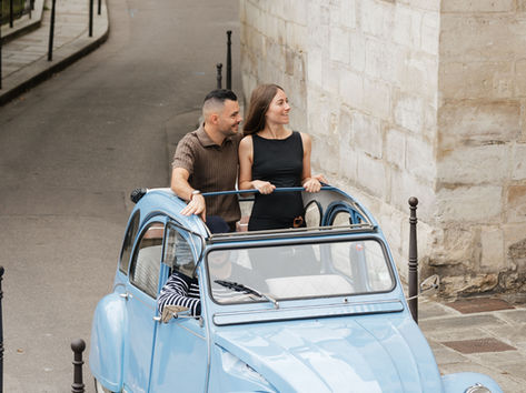 Couple in a blue 1978 2CV on a cobbled Paris street, private 2CV tour