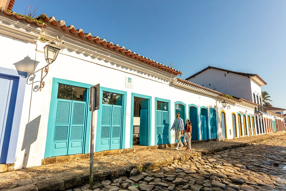 Visitantes extranjeros disfrutan de un paseo por las coloridas calles de Paraty, un destino que impulsa el turismo y la economía local en Brasil.