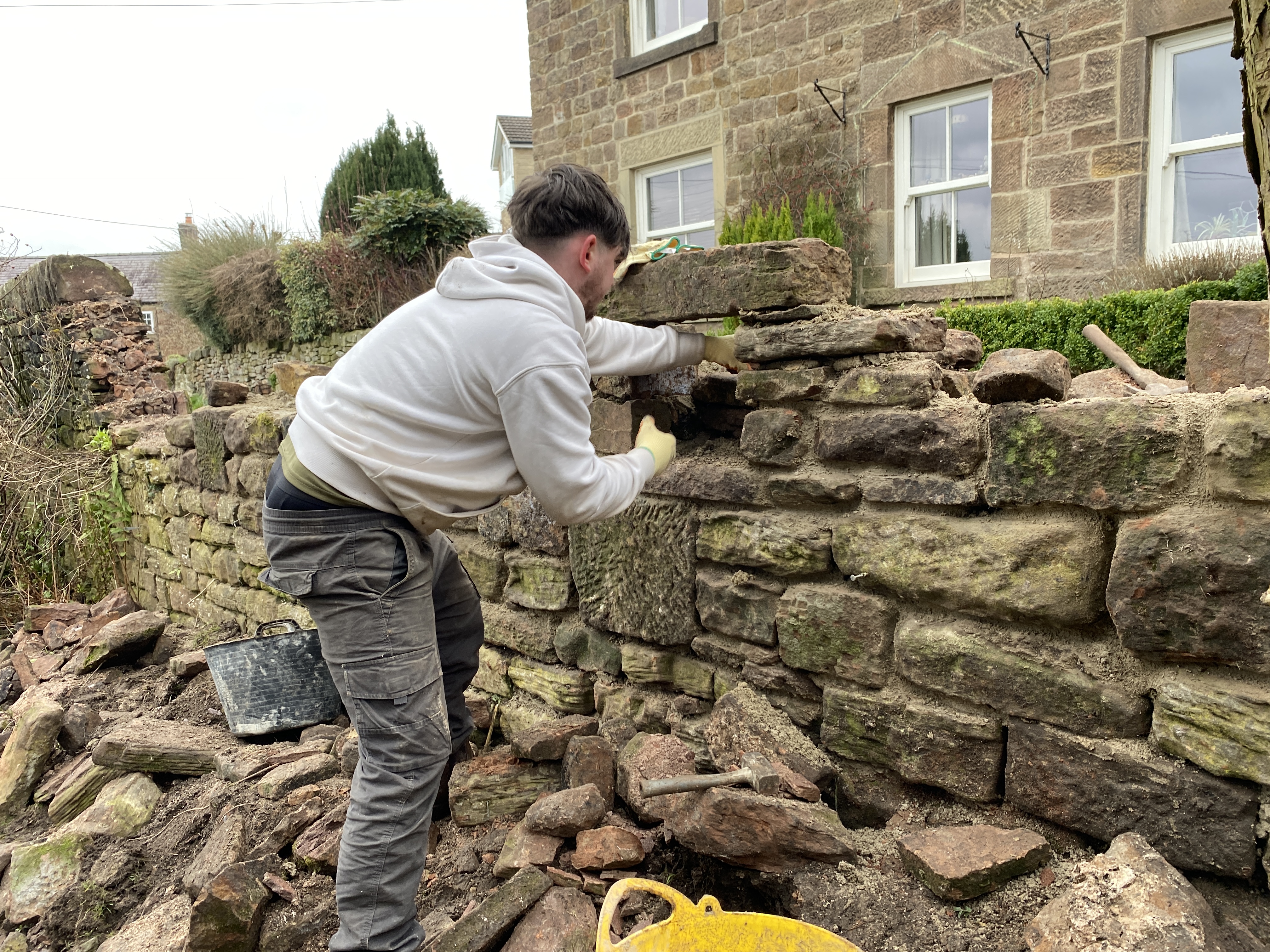 retaining stone wall being built in Matlock