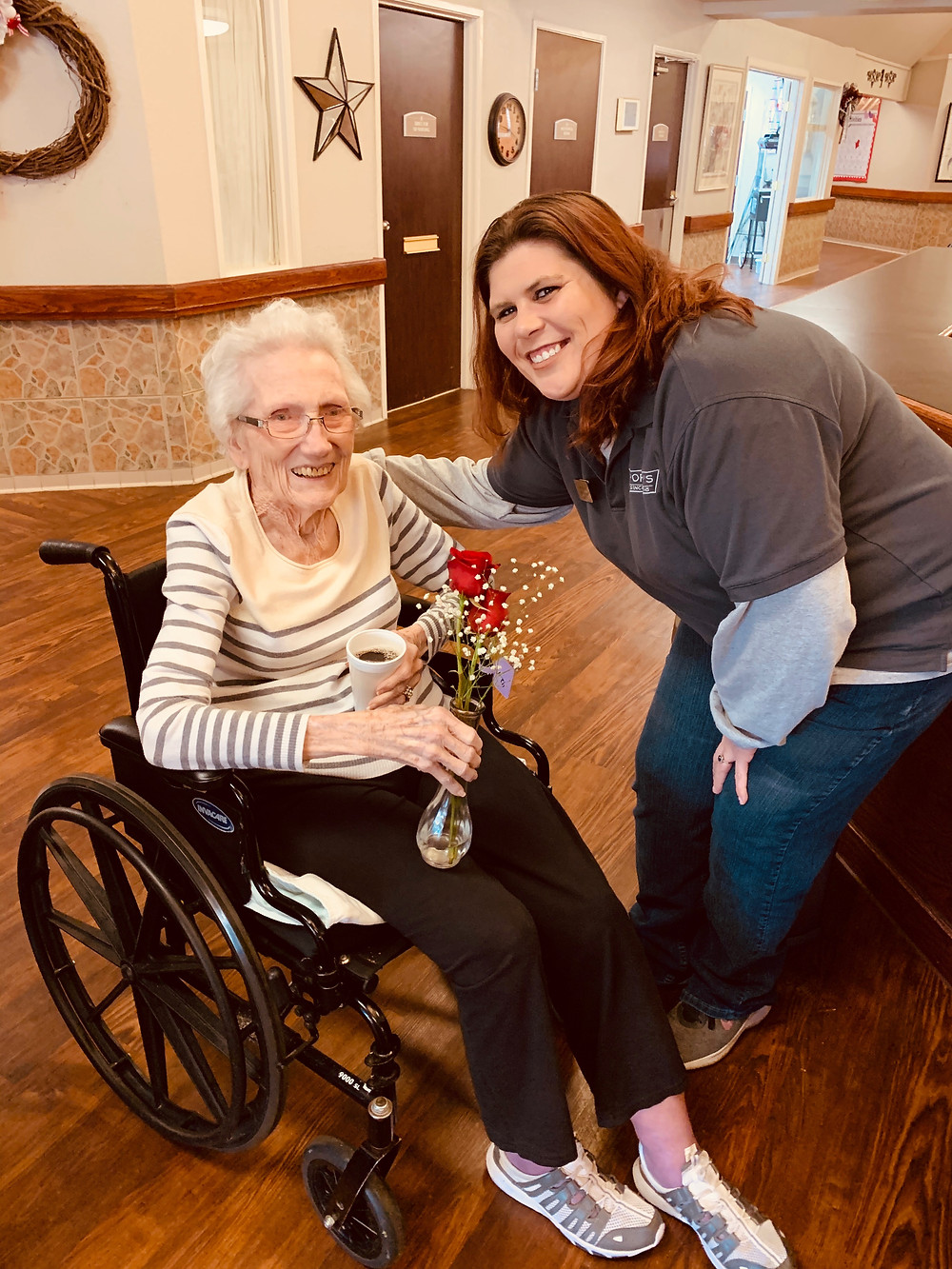 Team Member in Big Spring giving a rose to elderly woman for Valentine's.