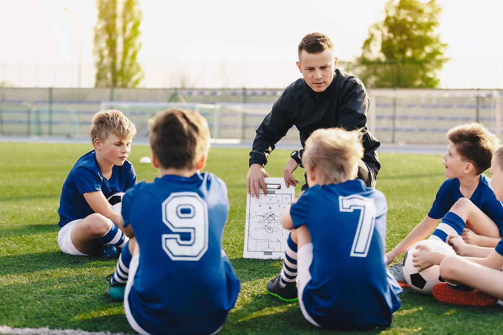 Coaching talking to a kids soccer team