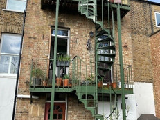 Green fire escape at side of property