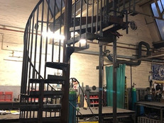 Winding metal stairs within warehouse 