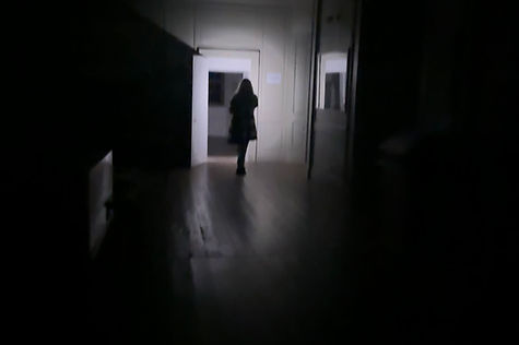 figure of woman in hall way