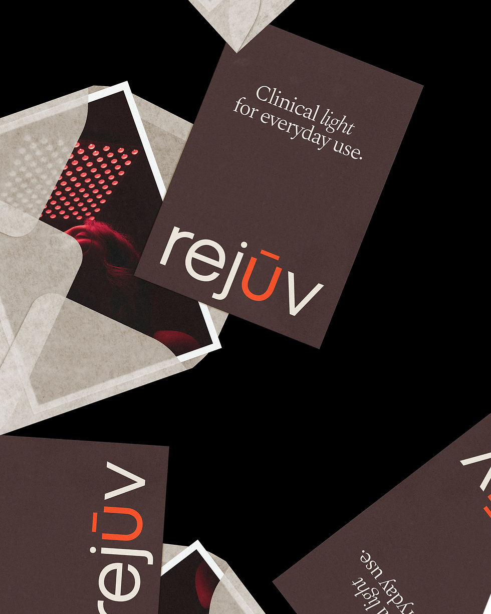 Rejuv business cards carrying the logo and the line "Clinical light for everyday use," arranged on a pale angular surface.