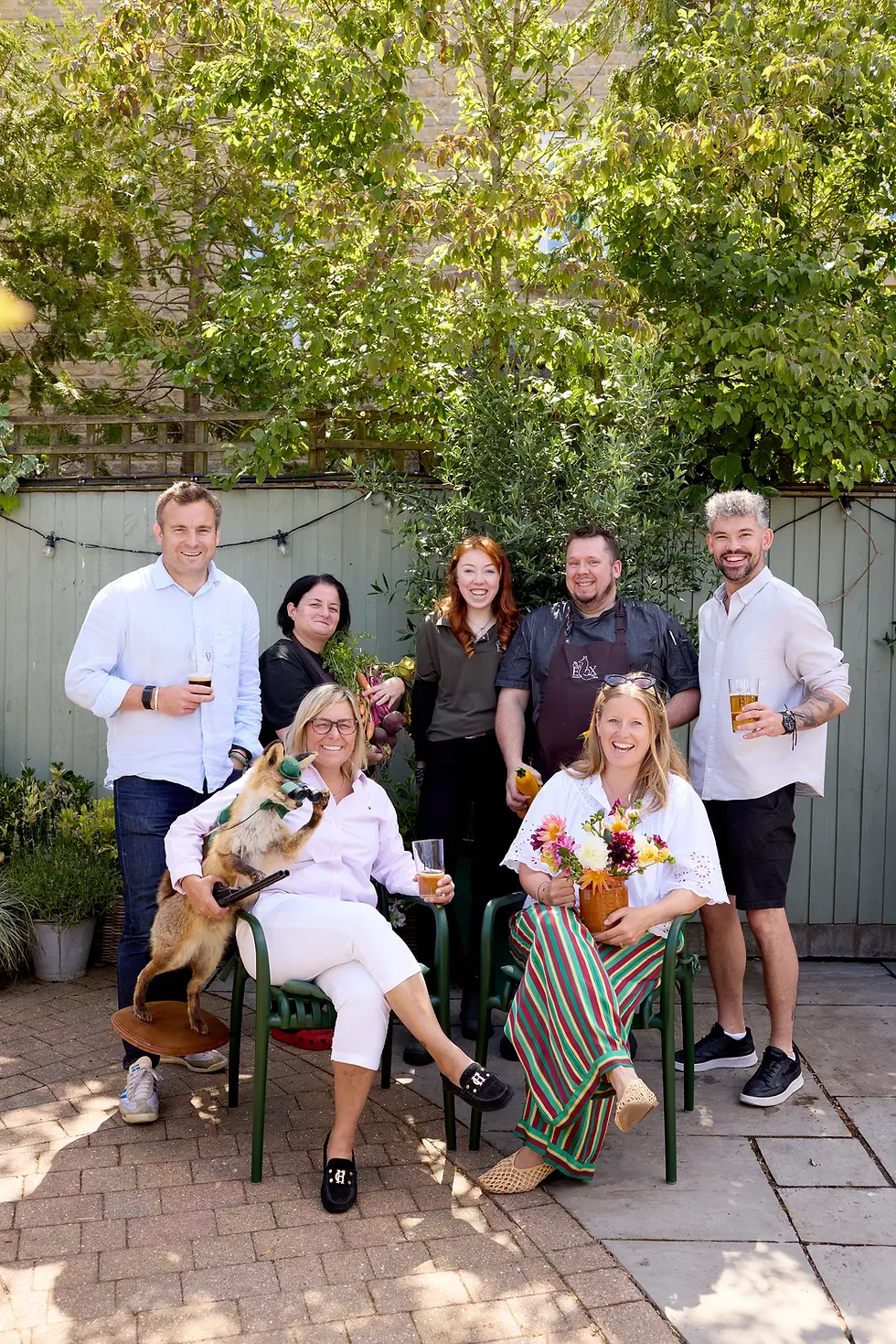 The Old Fox team and their dog gathered together in the garden of the village pub in Coaley