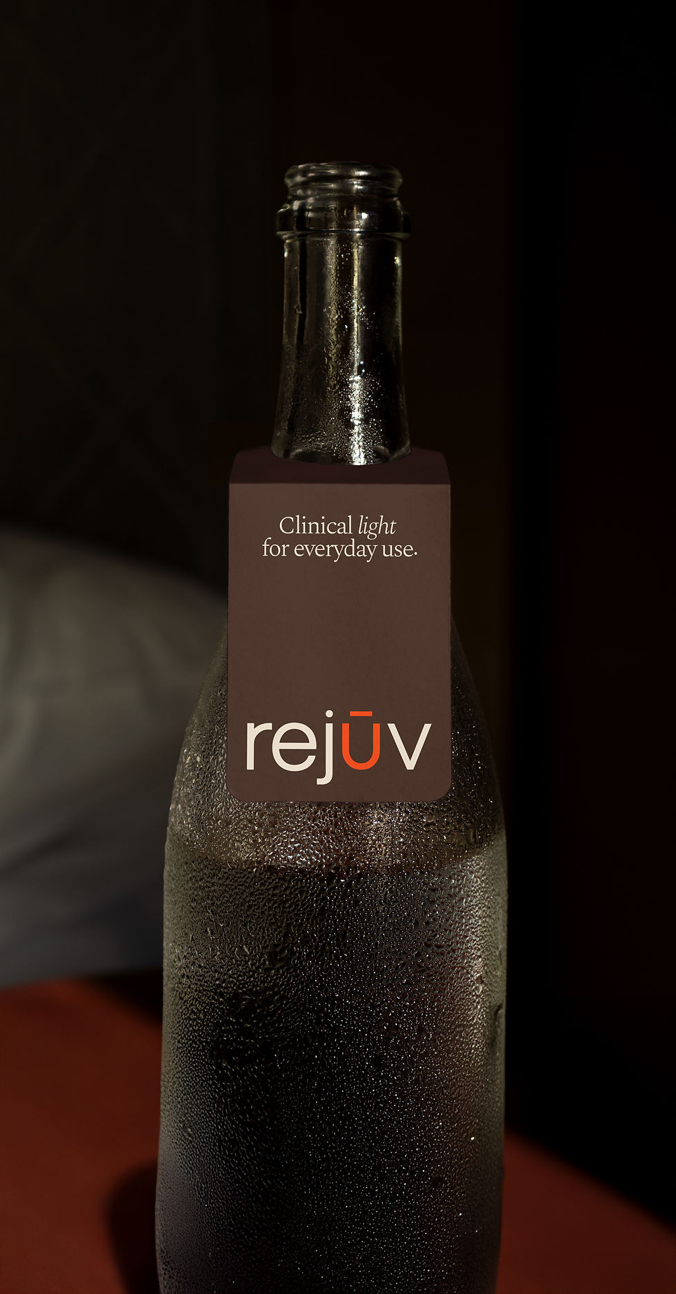 A dark Rejuv drink bottle carrying the line "Clinical light for everyday use" on a neutral background.