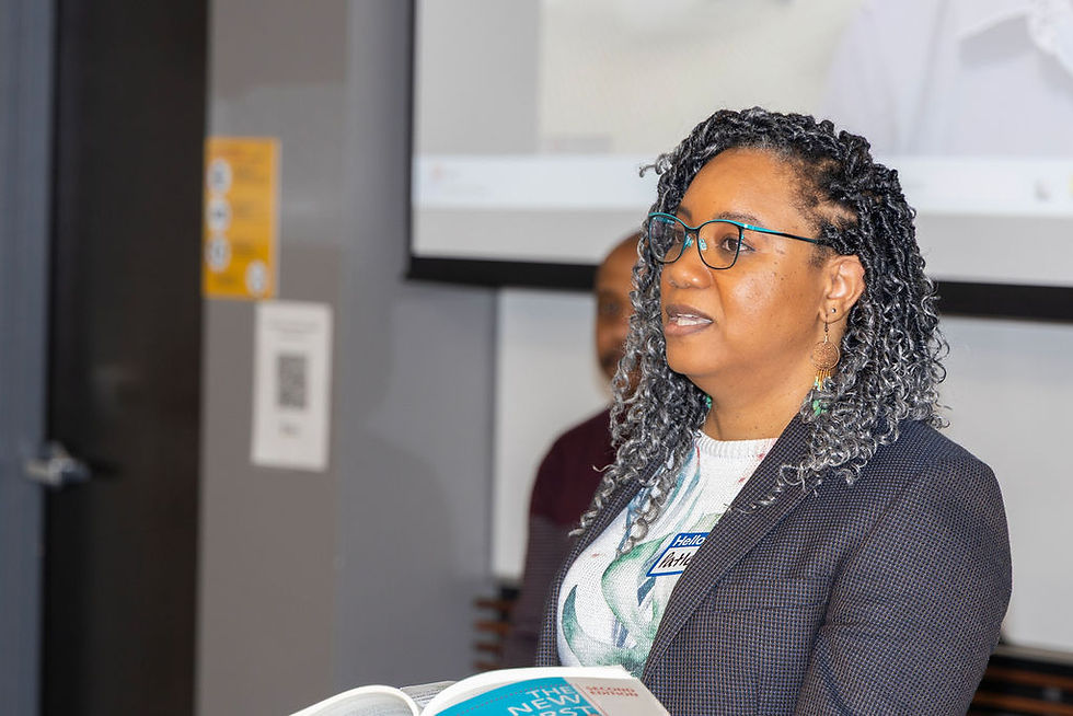 Woman with braided hair speaking at a presentation