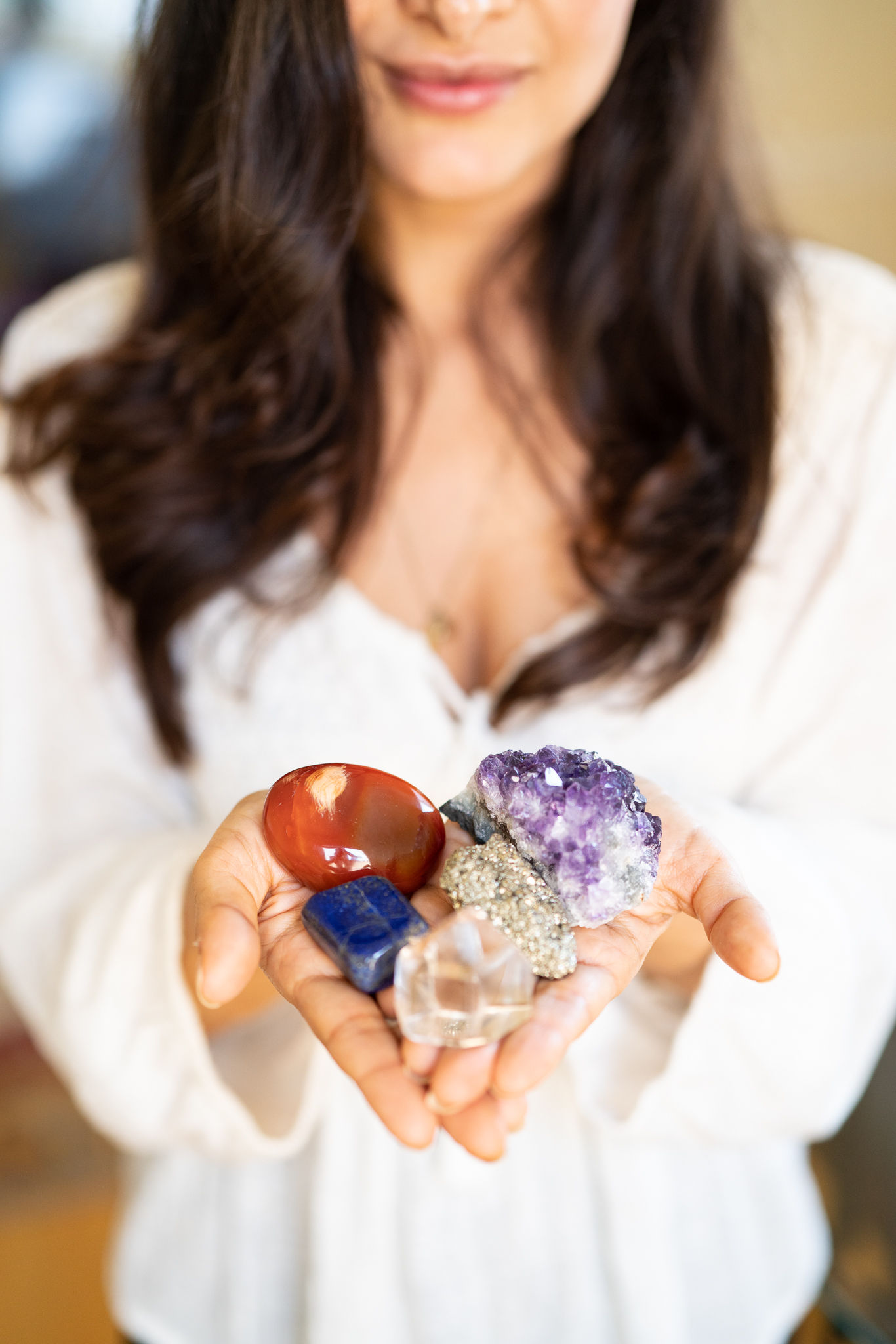 colorful raw and tumbled healing crystals for your reiki healing session with a reiki master and intuitive