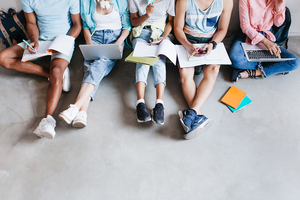 overhead-portrait-young-people-with-laptops-smartphones-sitting-together-floor-students-wr