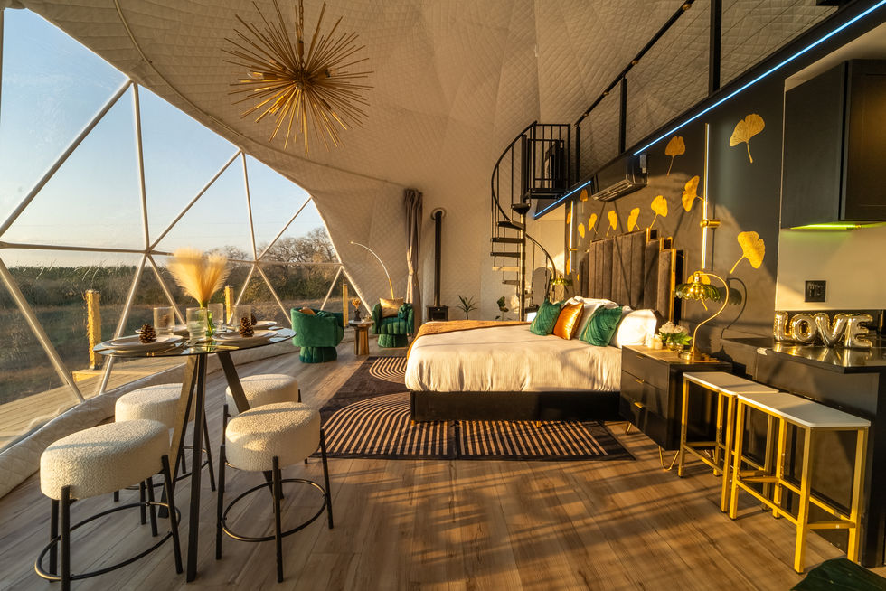 a bedroom with a king size bed and a spiral staircase