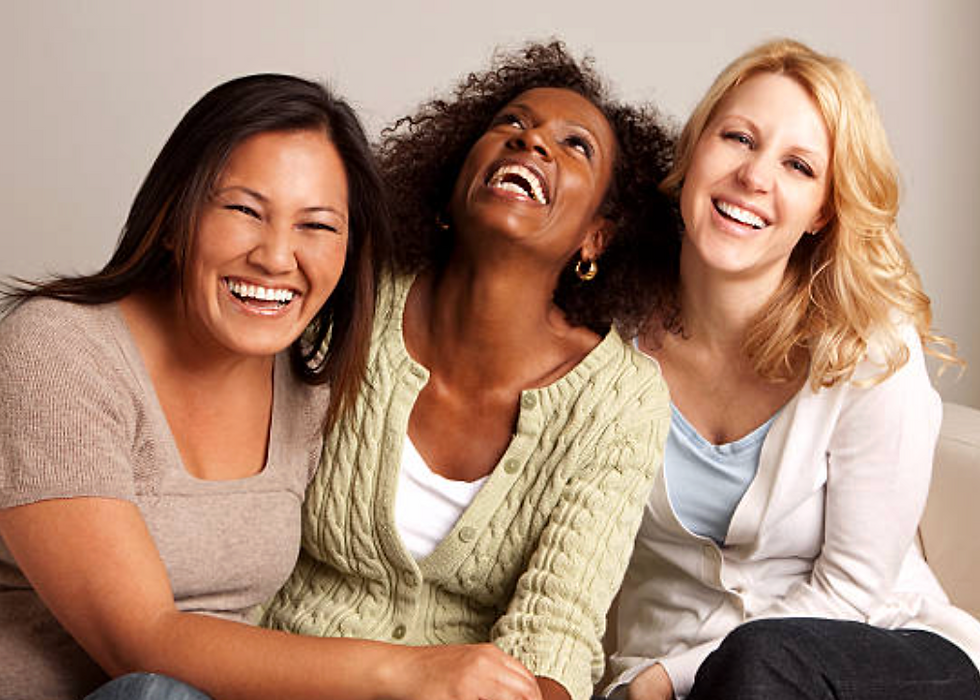 A group of women who are happy and smiling because they are not going broke while finding natural hair products to grow hair