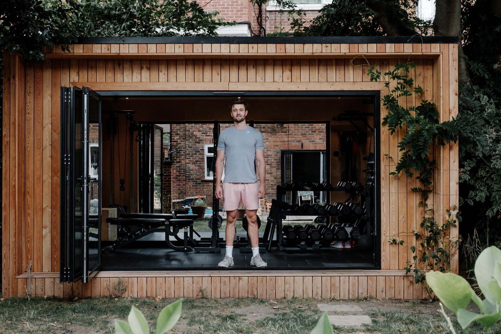 Jack standing in the open doors of his garden studio