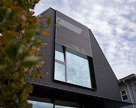 Black corrugated siding and sloped roof installed by JVI Architectural Sheet Metal