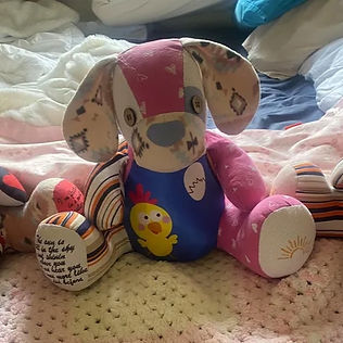 Patchwork Memory Bear handmade by Creatively Quirky using baby clothes in pink, purple and patterned fabric. Custom keepsake