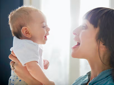Mother and baby smiling at each other