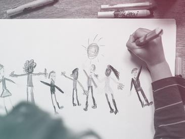 child drawing a picture of people