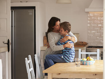 Mother hugging son