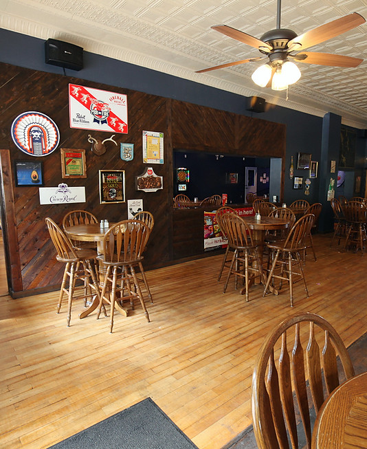 Interior of a bar and grill in Vandalia IL with wooden tables