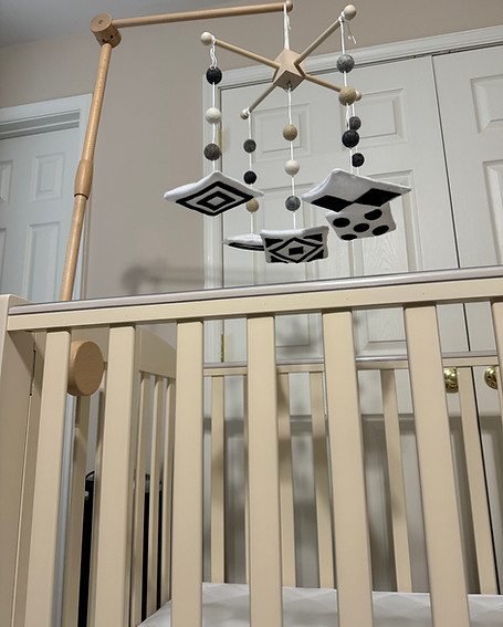 Black and white crib mobile over crib