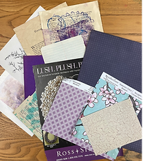 Assorted patterned, printed and textured papers gathered for a simple collage