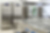 Commerical kitchen equipment, including coolers, prep counters, and sinks