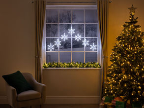 christmas living room scene with snowflake curtain lights