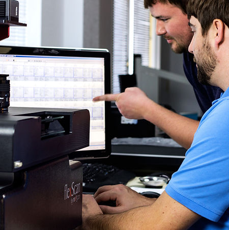 men scanning microfilm