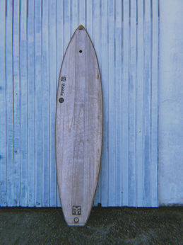 full-length view of a handcrafted wooden surfboard
