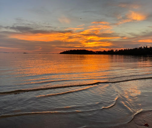 Sunset over shallow water with reflections