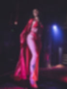 Performer in red robe and lingerie on stage