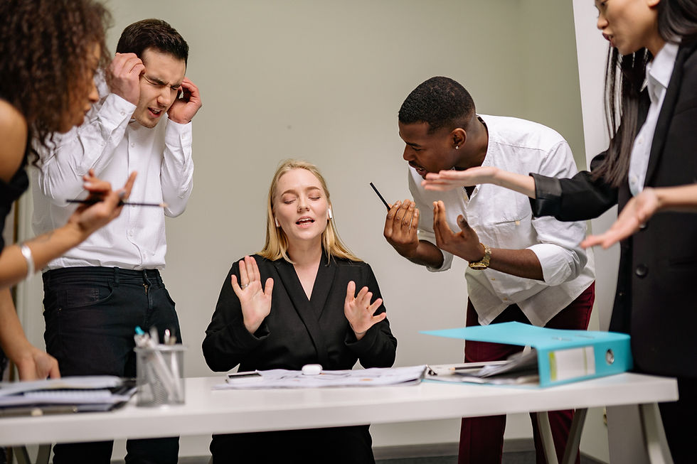 A professional leader sitting calmly in a tense meeting while everyone around them appears stressed or reactive.