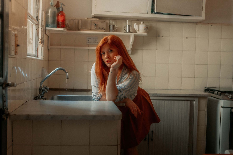 Red haired woman stood in vintage-style kitchen