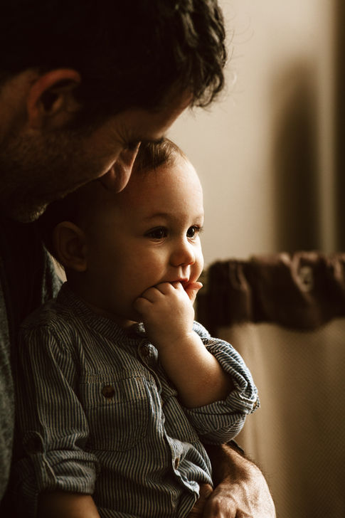 a small child sitting on a parents lap.
