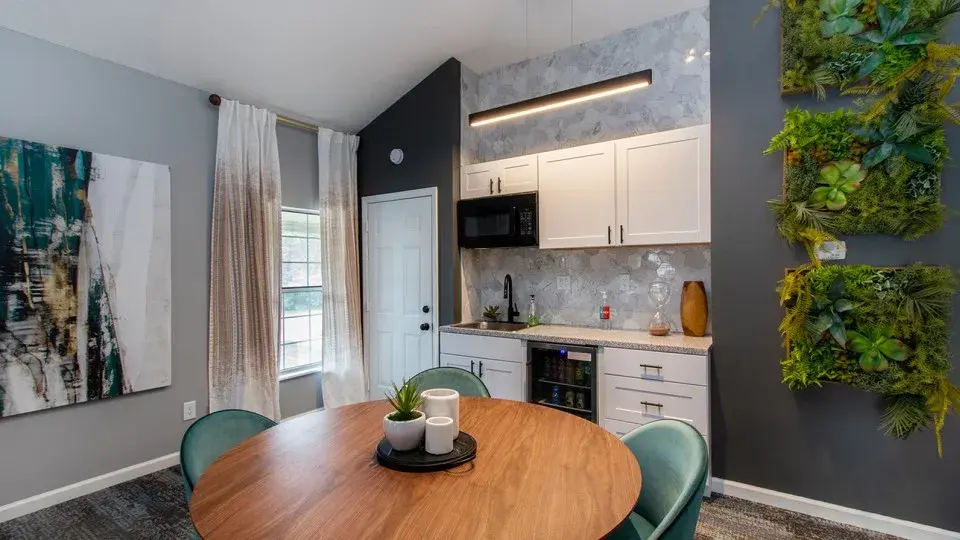 Sofa, couch, floor lamp, lamp, smoking chair, recliner, chair, rug, carpet, hardwood floor, window, window treatment, plant, natural light, light fixture, chandelier fireplace, painted brick, accent wall, time, coffee table, side table, arm chair, games, gameroom, recreation room