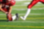 American football player placing ball for kickoff on field in Vancouver