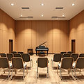 small auditorium with a piano; the piano should be to the side and front of the room; and