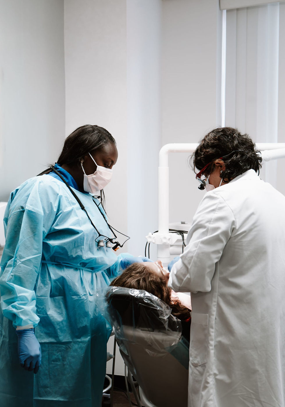 Dentist performing a tooth extraction procedure at Avalon Dental Center in Cambridge, MA.