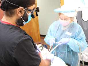 Dentist performing a wisdom tooth extraction procedure at Avalon Dental Center in Cambridge, MA.