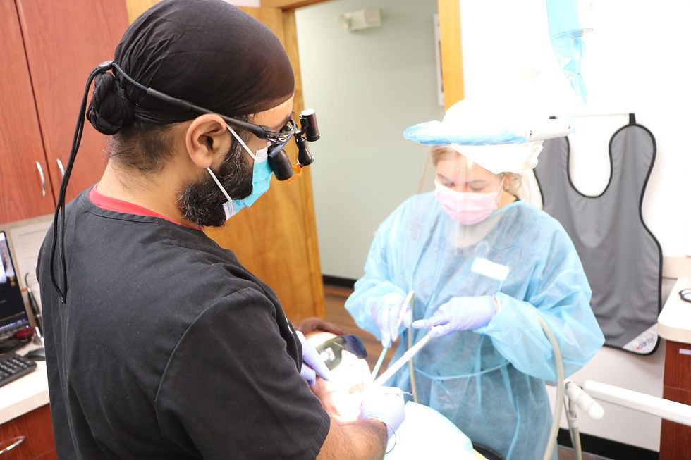 Dentist performing a wisdom tooth extraction procedure at Avalon Dental Center in Cambridge, MA.