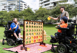 2-wheelchair-users-playing-Connect-4-first2care-ndis-plan-support-australia