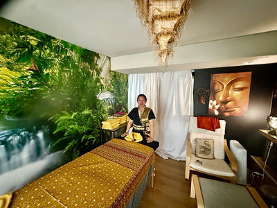 Nidtaya beside the massage table in the Northwich treatment room