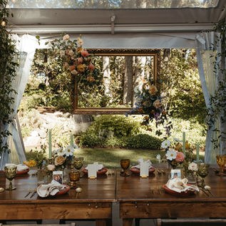 a vintage table setting in a white wedding tent