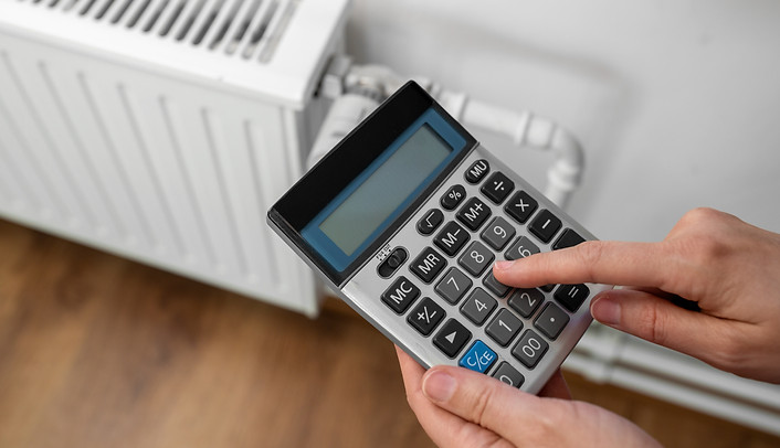 close-up-hand-with-calculator-home-radiator.jpg
