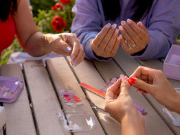 Close-up of varied press-on nail styles on hands