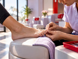 Technician examining runner’s foot before pedicure