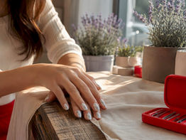 Hands with glossy white gray marble wedding nails